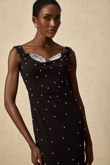 A black midi dress with faux pearl embellishments called Apolline