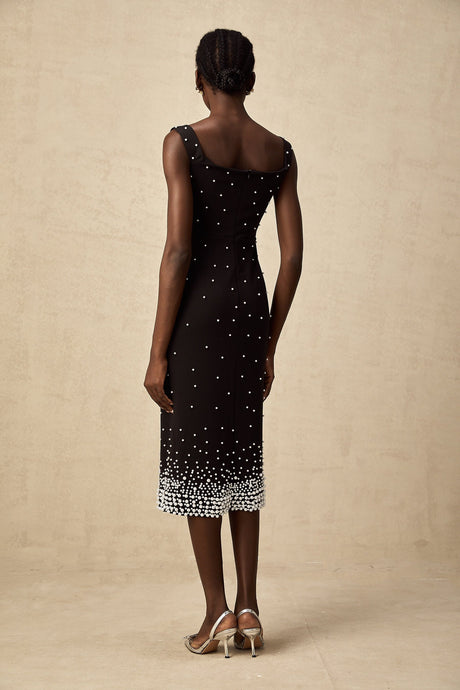 A black midi dress with faux pearl embellishments on the bodice named Apolline