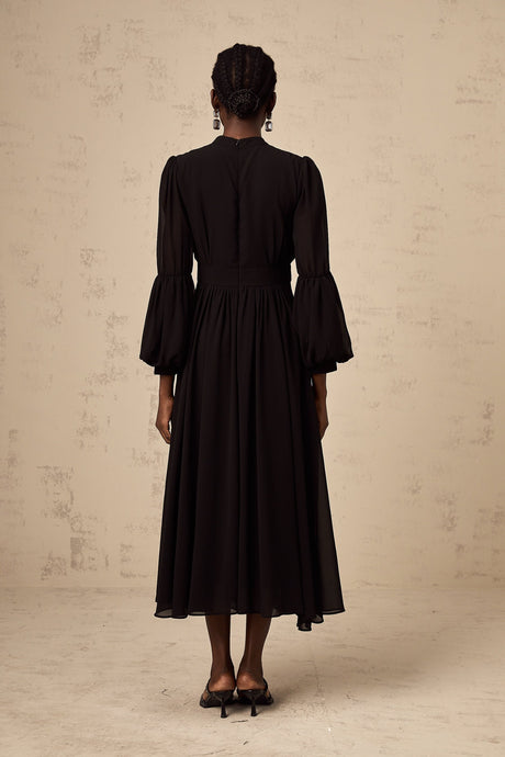 A black midi dress with pleated details and a buttonfront design called Viviane
