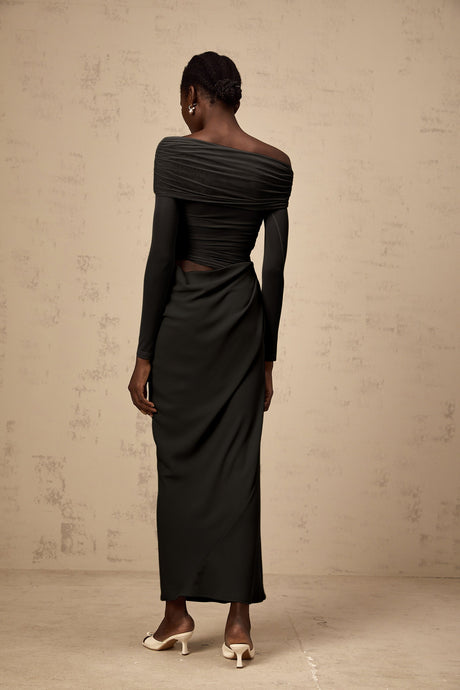 A black offshoulder midi dress with a semisheer design worn by a model standing against a plain background