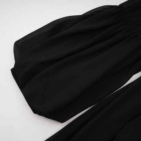 A black pleated midi dress with a buttonfront design featuring long sleeves and a fitted waist