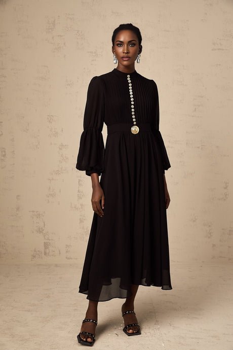 A black pleated midi dress with a buttonfront design featuring the name Viviane