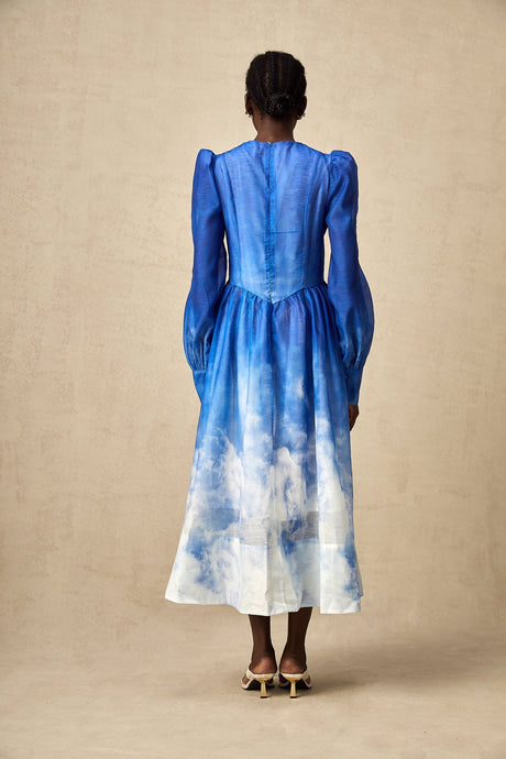 A blue gradient pleated midi dress with a flowing silhouette and gradual color transition from light to dark blue