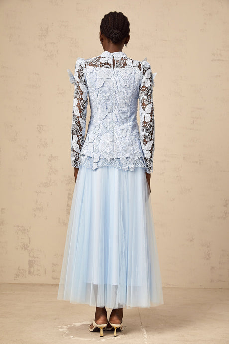 A blue matching set consisting of a sequined lace top and skirt in a similar style The top is sleeveless with a fitted silhouette while the skirt is likely knee length Both pieces feature allover blue sequins and lace detailing creating a shimmering elegant look