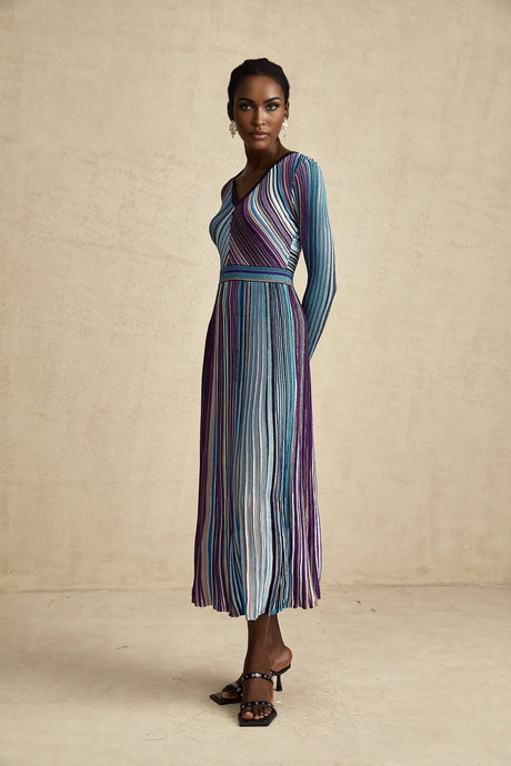 A blue metallic midi dress with pleated design named Mathilde featuring a shimmering fabric and falling to mid calf length