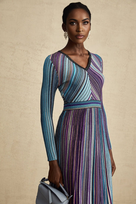 A blue metallic pleated midi dress named Mathilde on a plain background