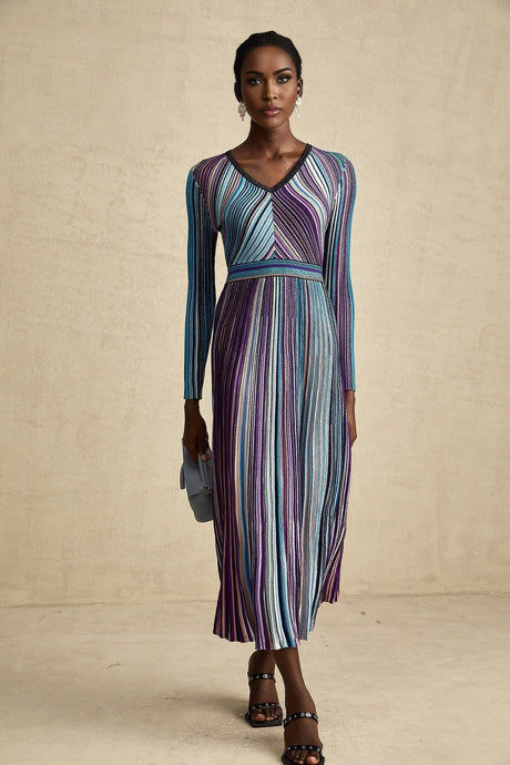 A blue metallic pleated midi dress named Mathilde with a shimmering fabric and flowing skirt