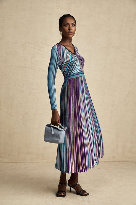 A blue metallic pleated midi dress with a flowing silhouette and shimmering fabric named Mathilde