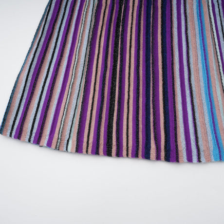 A blue metallic pleated midi dress with a flowing skirt and shimmering fabric named Mathilde