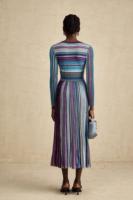 A blue metallic pleated midi dress with a sleek and elegant design featuring a shimmering fabric and flowing silhouette