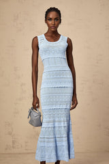 A blue midi dress with crochet knit detailing and ruffled trim accents