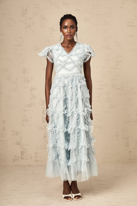 A blue midi dress with delicate dot details and ruffled accents named Corinna