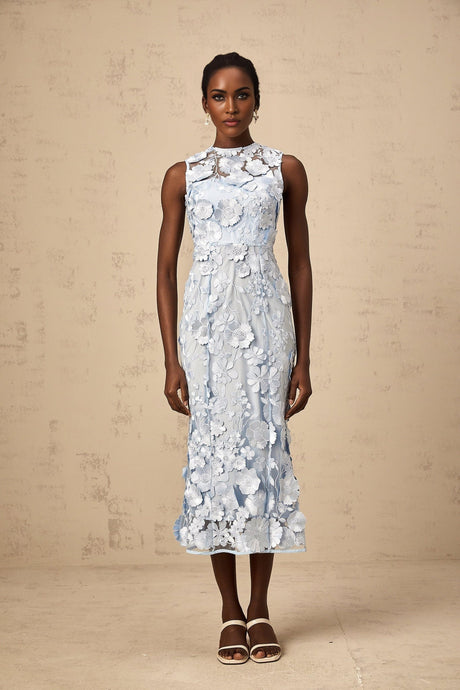 A blue midi dress with floral applique details featuring the Herta design