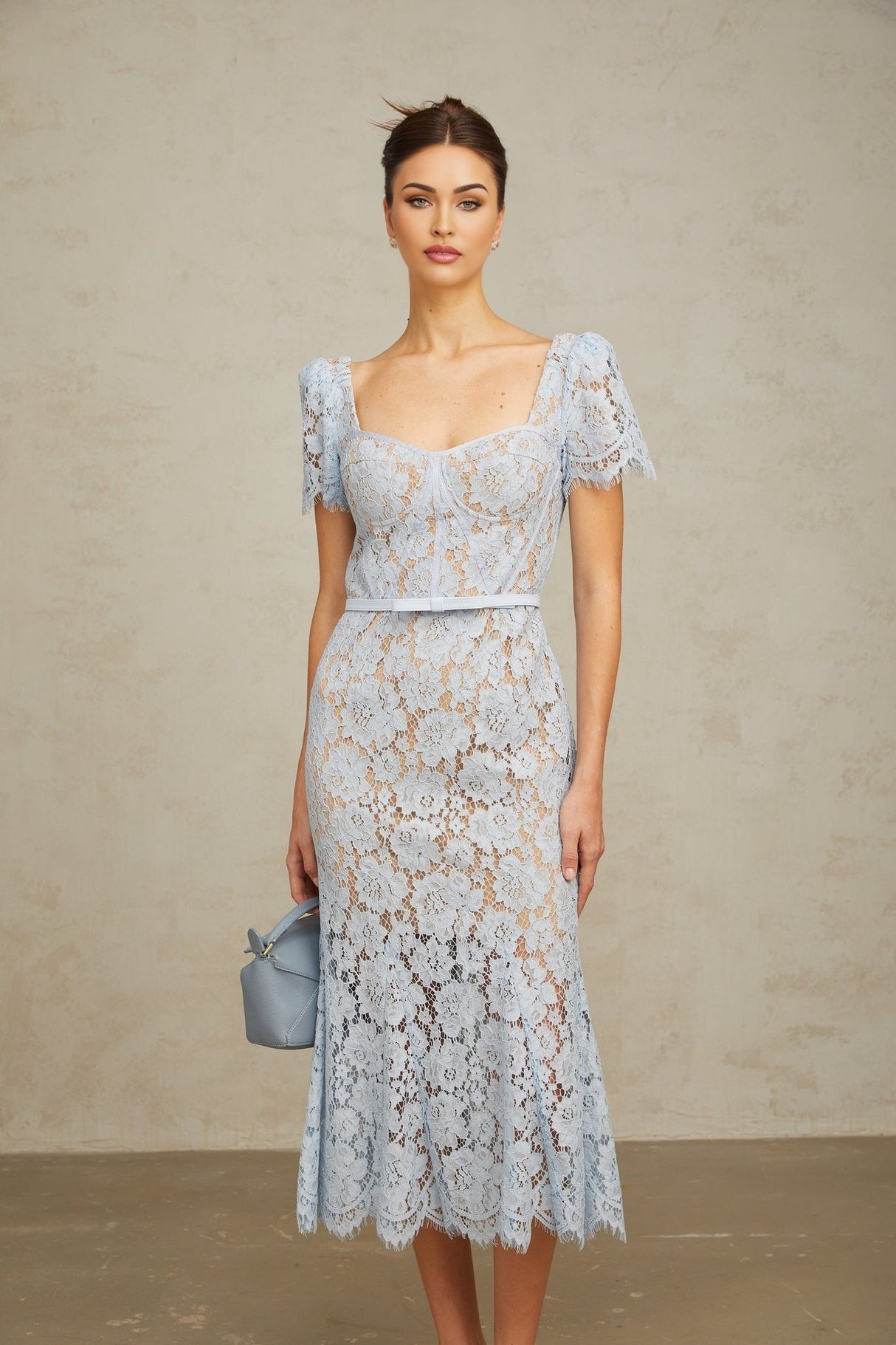 A blue midi dress with floral lace pattern and boned structure named Audrey