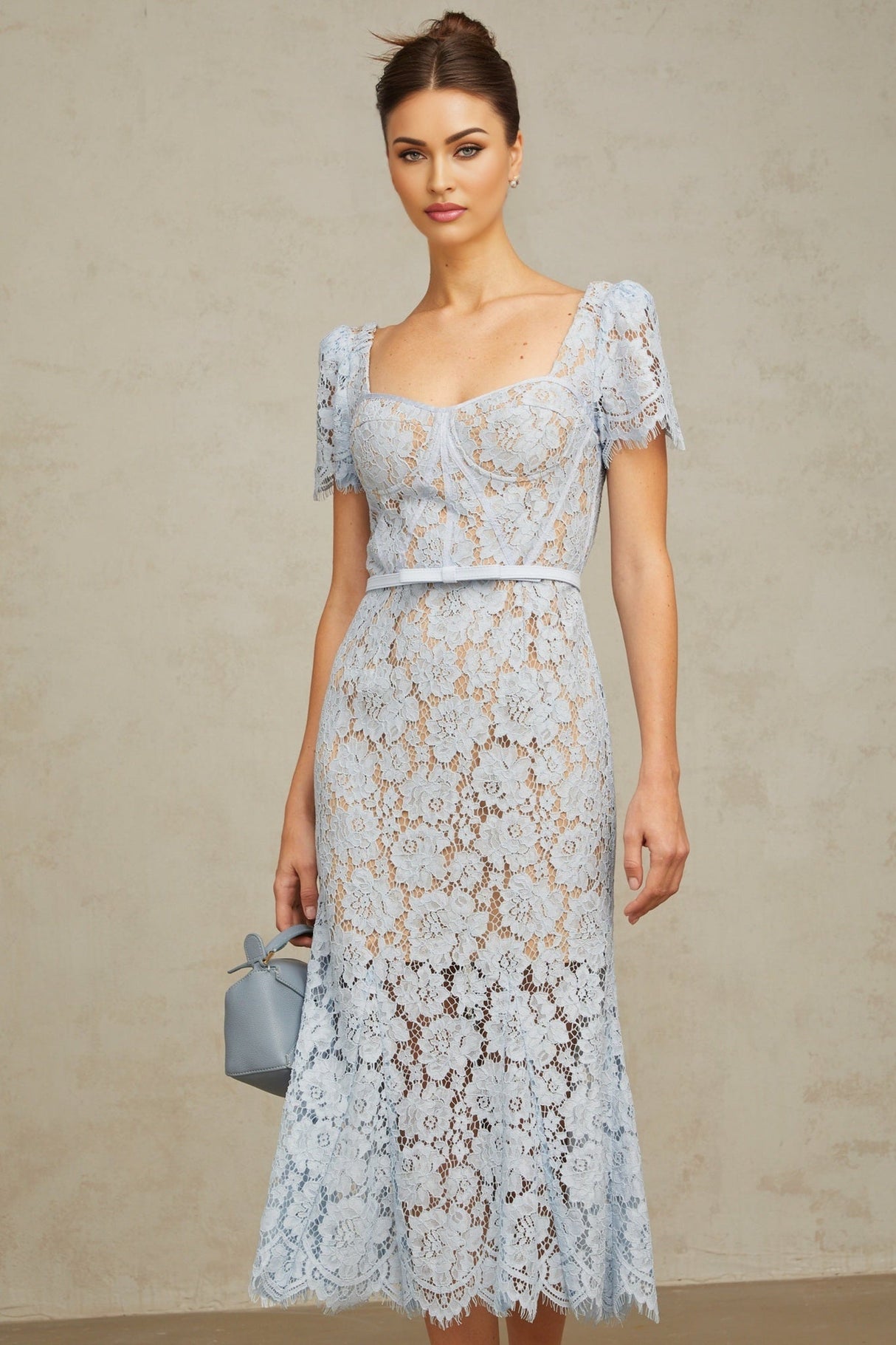 A blue midi dress with floral lace pattern featuring boned structure and named Audrey