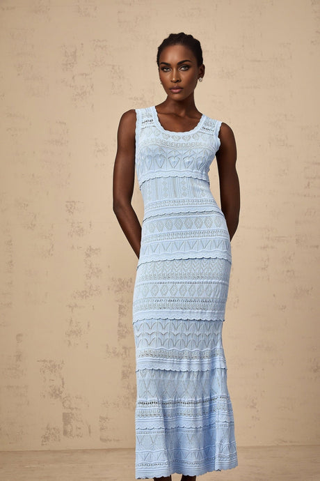 A blue midi dress with ruffled trim and crochet knit design featuring a feminine silhouette and delicate texture
