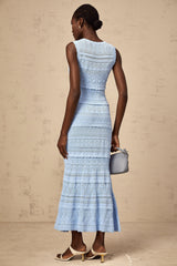 A blue midi dress with ruffled trim and crochet knit design featuring a sleeveless silhouette and form fitting shape