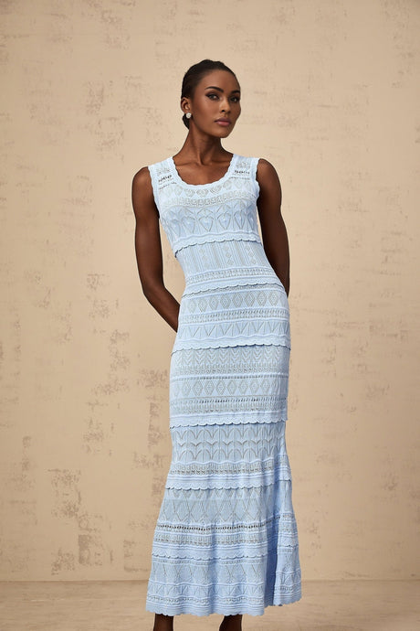 A blue midi dress with ruffled trim and crochet knit pattern featuring a feminine silhouette and delicate details