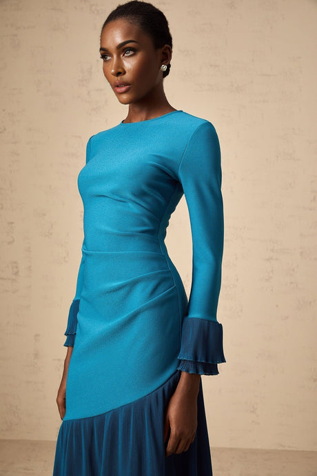 A blue midi dress with ruffled trim and paneled design featuring a feminine silhouette and delicate details