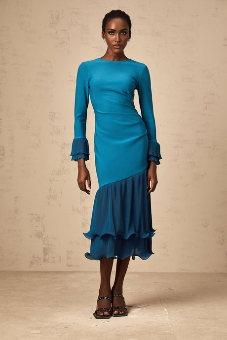 A blue midi dress with ruffled trim and paneled design featuring a feminine silhouette and flowing fabric