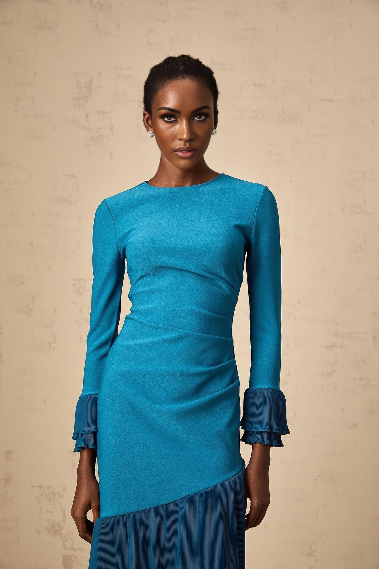 A blue midi dress with ruffled trim and paneled design featuring a fitted silhouette and feminine details