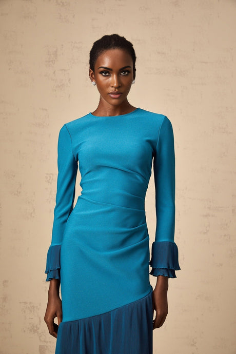 A blue midi dress with ruffled trim and paneled design featuring a fitted silhouette and feminine details