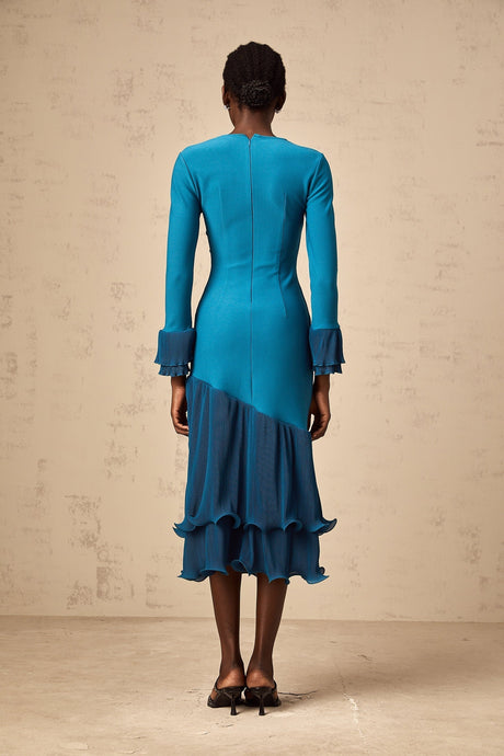 A blue midi dress with ruffled trim and paneled design featuring a flowy silhouette and feminine details