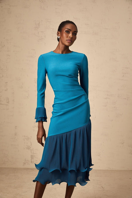 A blue midi dress with ruffled trim and paneled design featuring a flowy silhouette and feminine details
