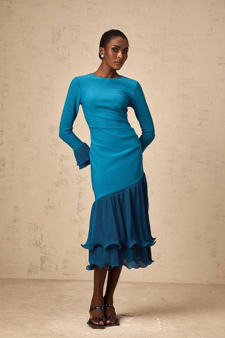 A blue midi dress with ruffled trim and panelled design featuring a fitted silhouette and feminine details
