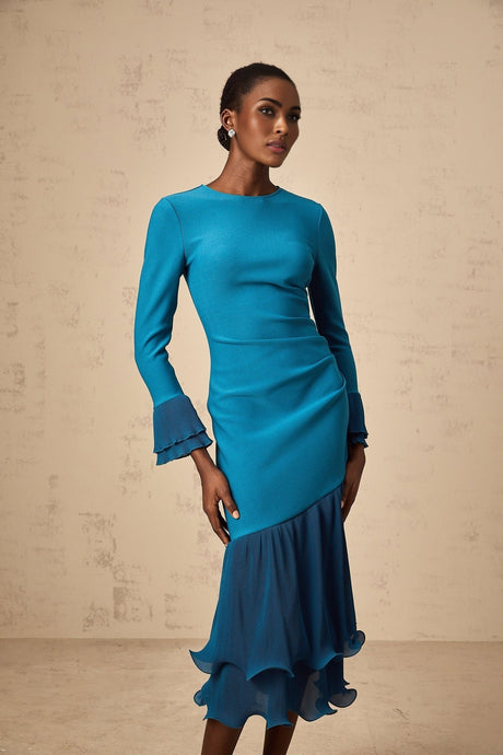 A blue midi dress with ruffled trim and panels featuring a feminine silhouette and delicate details