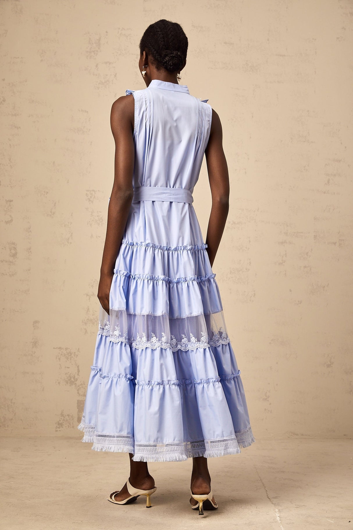 A blue midi dress with ruffles and floral lace trim featuring a tiered skirt design named Olena