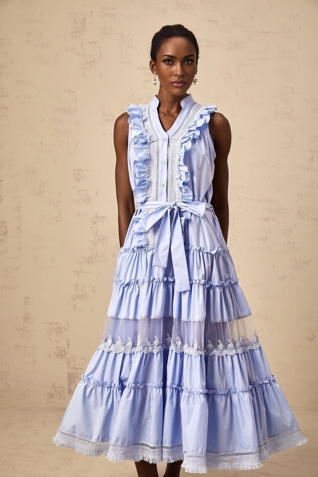 A blue midi dress with ruffles and floral lace trim featuring a tiered skirt design named Olena