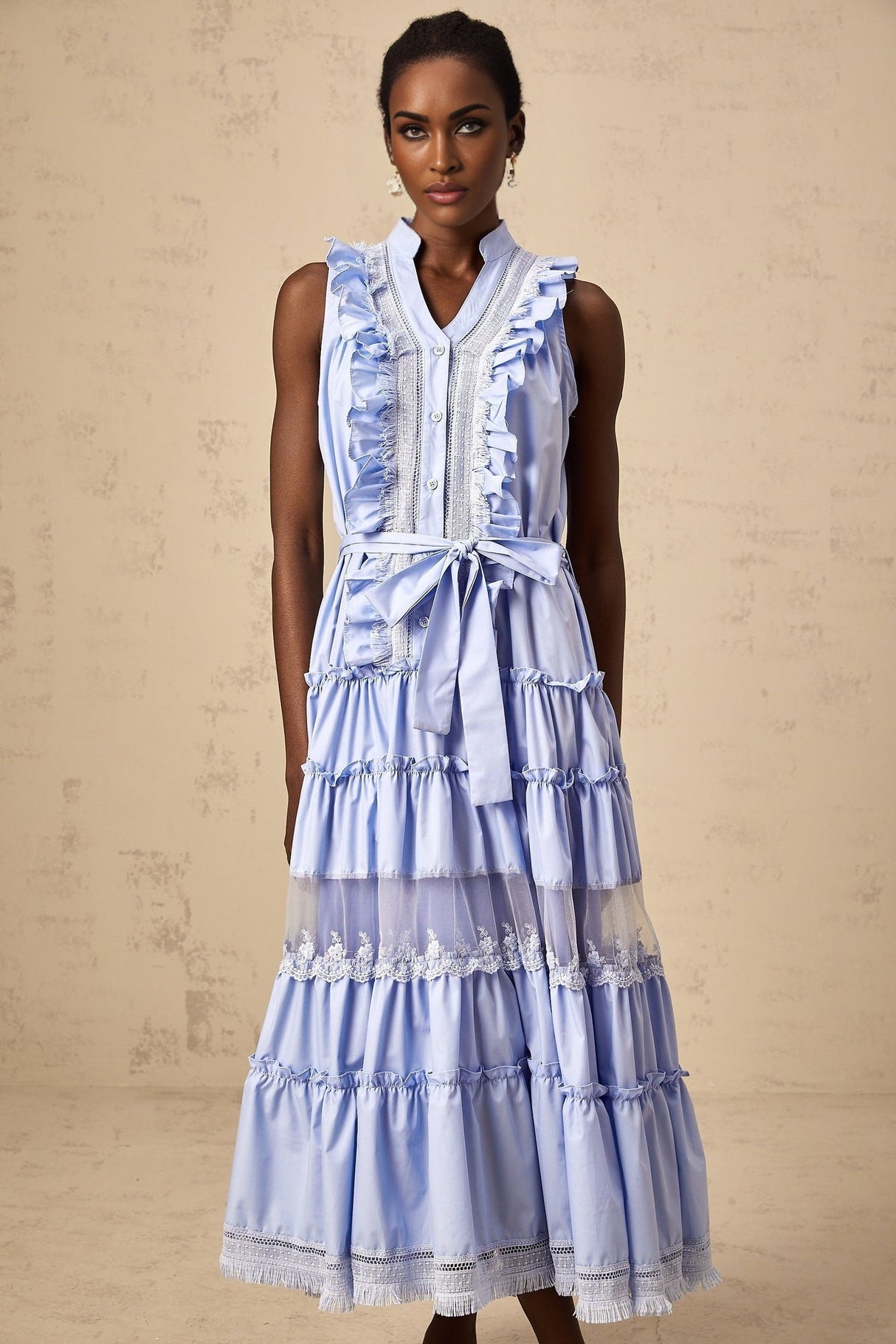 A blue midi dress with ruffles and floral lace trim featuring tiered layers and a feminine silhouette