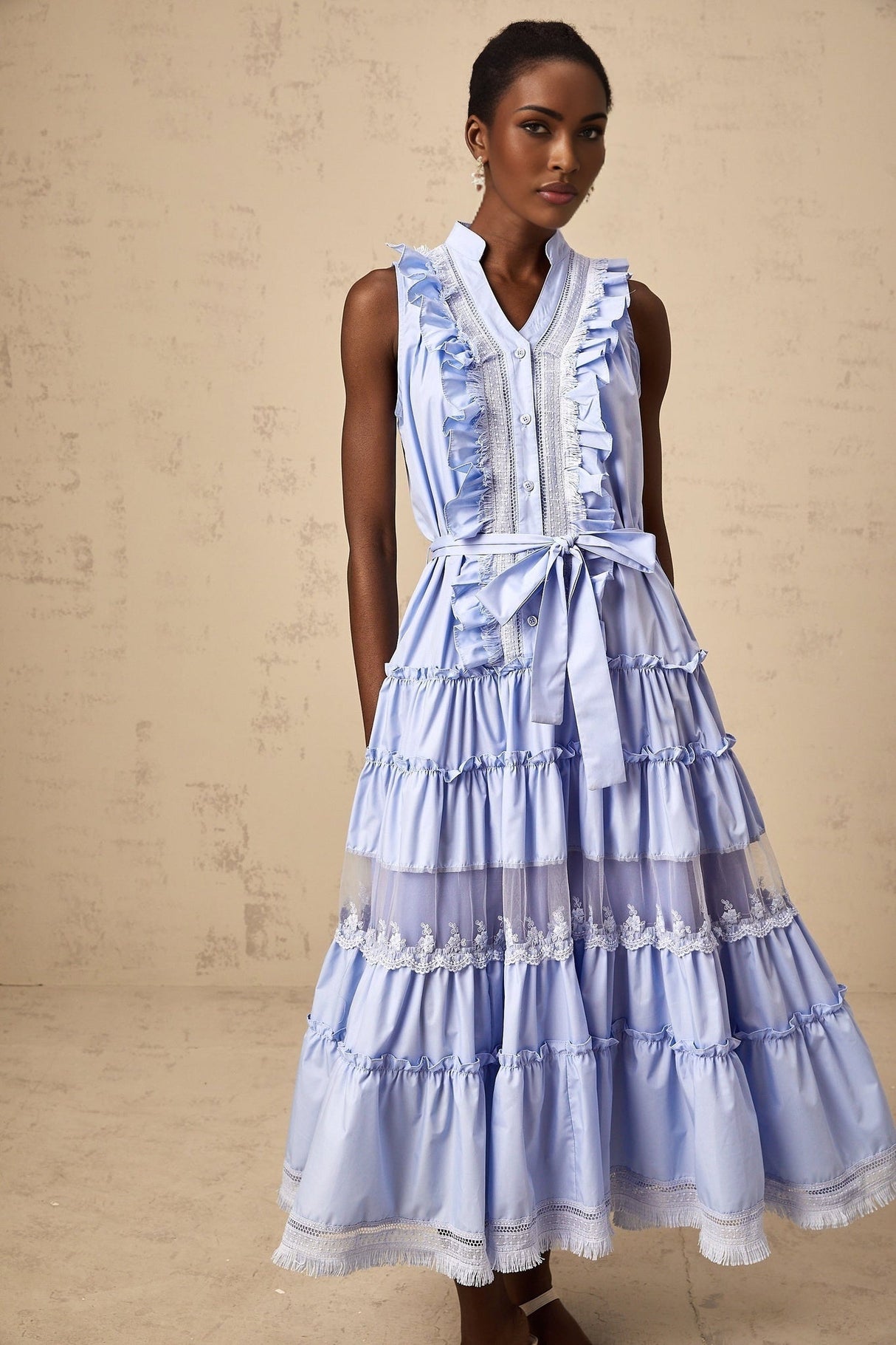 A blue midi dress with ruffles and floral lace trim featuring tiered layers named Olena