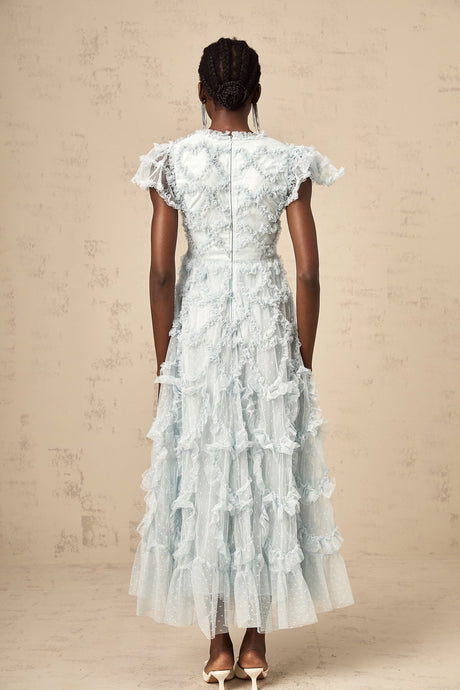 A blue midi dress with ruffles and small dot details named Corinna