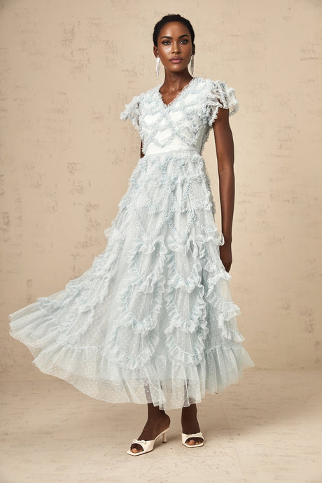 A blue midi dress with ruffles and small dot details named Corinna