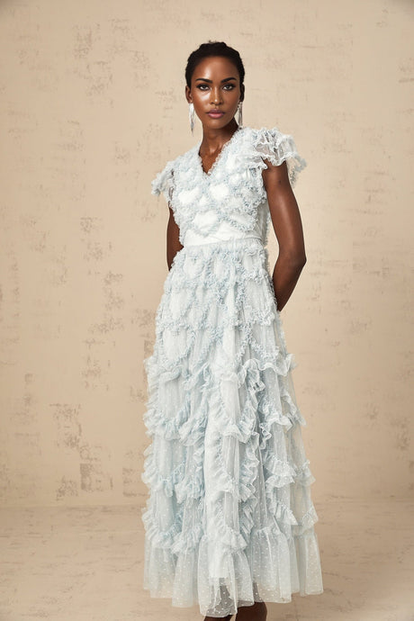 A blue midi dress with ruffles and small dot details named Corinna