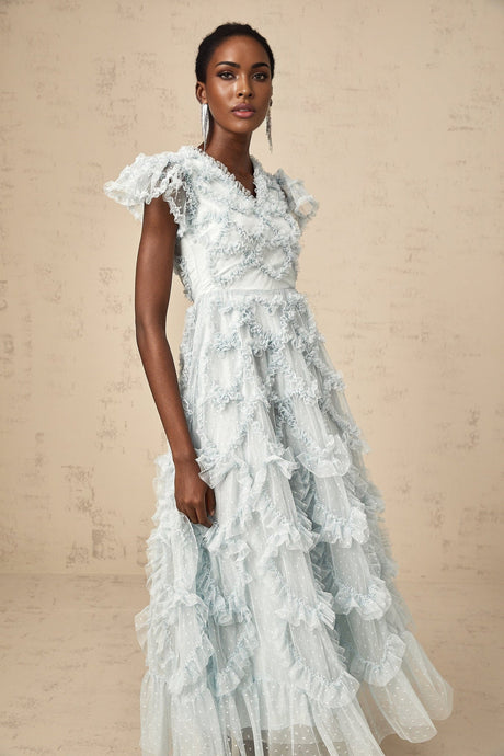 A blue midi dress with ruffles and small dot details named Corinna