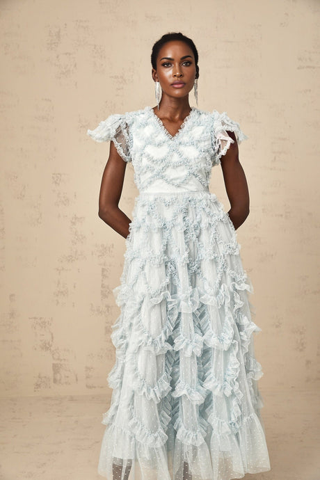 A blue midi dress with ruffles and small dot details named Corinna