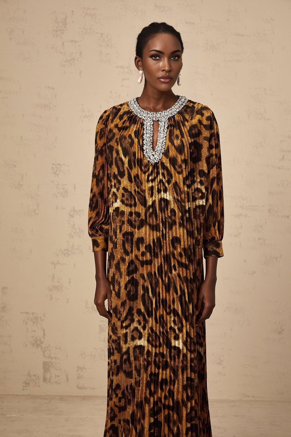 A brown leopard print midi dress with embellishments named Anais worn by a model standing against a plain background