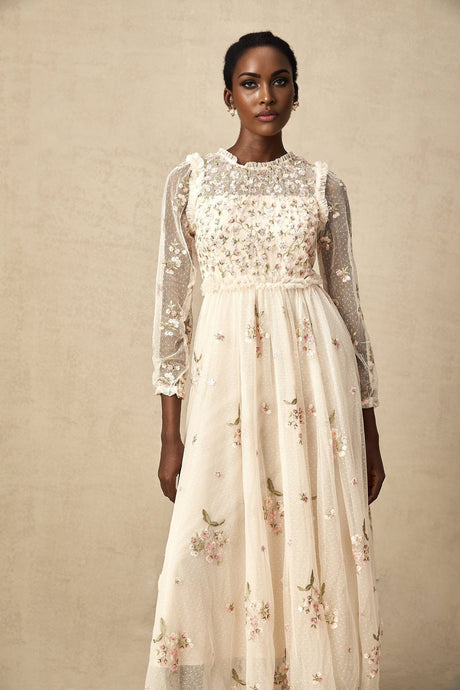 A Celine midi dress made of tulle fabric featuring delicate floral embroidery throughout