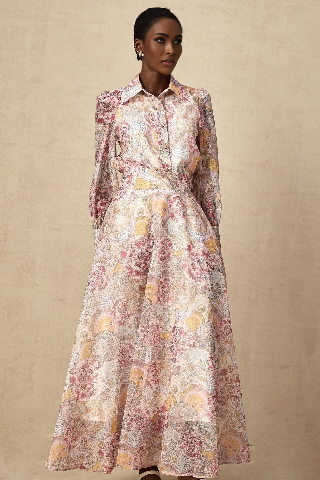 A child wearing a cherry pink shirt and skirt set with a pattern print design The top and bottom match creating a coordinated outfit