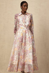 A child wearing a cherry pink shirt and skirt set with a pattern print design The top and bottom match creating a coordinated outfit