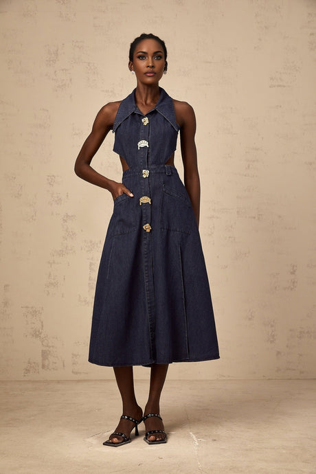 A dark blue denim midi dress with cut out details on a white background