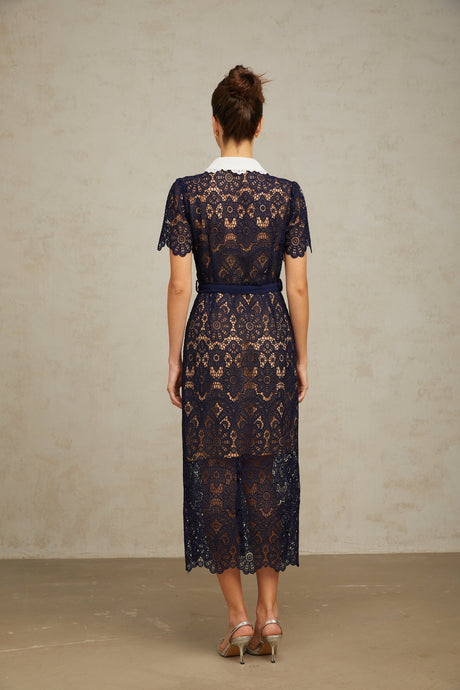 A dark blue midi dress with a floral crochet lace pattern covering the entire garment