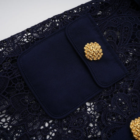 A dark blue midi dress with a floral crochet lace pattern covering the entire garment