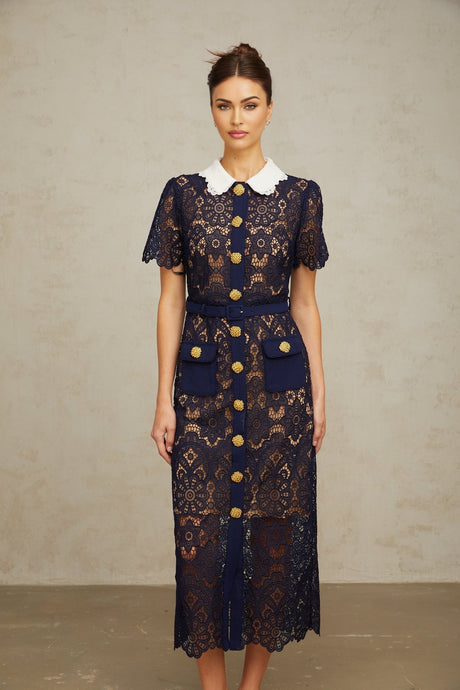 A dark blue midi dress with floral crochet lace detailing named Ariane