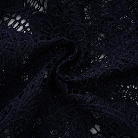 A dark blue midi dress with floral crochet lace pattern and a fitted silhouette