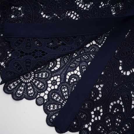A dark blue midi dress with floral crochet lace pattern and delicate detailing