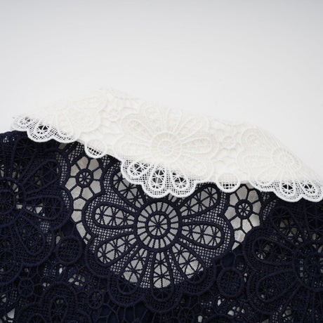 A dark blue midi dress with floral crochet lace pattern and delicate details